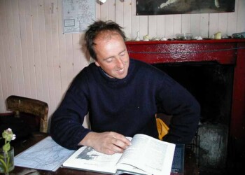 Adam Nicolson in his house on the Shiants July 2000 Man reading a book