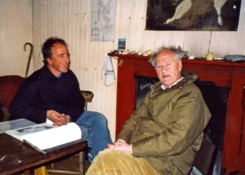 Adam Nicolson and his father Nigel in their house on the Shiants on July 2000. This is the first and only time they were both ther at the same time. 2 men sitting in a room