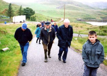 A group of mixed age walking up a hill