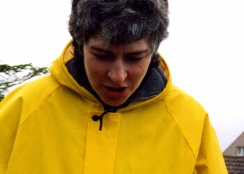 A person in a yellow waterpoof jacket