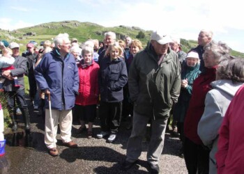 Roddy relates some his early memories of Calbost to the assembled audience Group listening to man talking outdoors