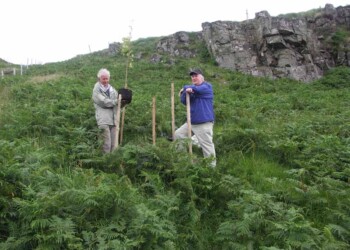 John and Donnie planting a memorial tree at the end of the walk 2 men planting a tree
