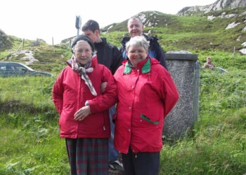 On the way into the meeting house for the service at the end of the day Group of 4 against hill