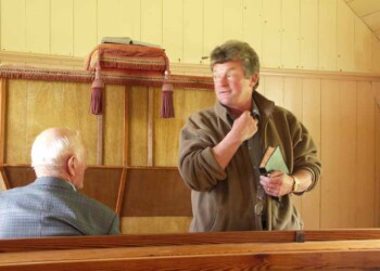 Presenting the psalm Man standing in meeting hall