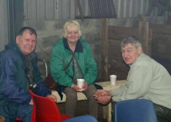 Enjoying the company over a brew. 3 people sitting drinking tea