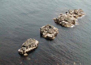 Unusual formation rising out of the sea at the Shiants 3 small islands showing rock separated into columns