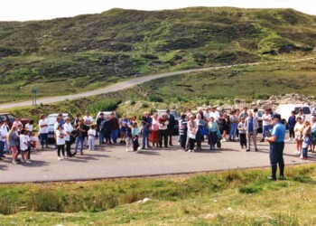 Briefing from Calum before we leave for Stiomreway A man talking to a group on a road