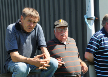 3 men outside a barn
