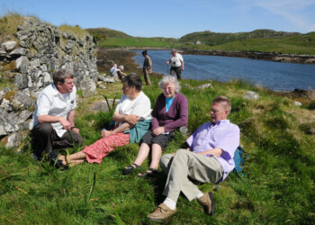 Group taking a break in front of a dry stone building