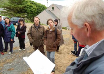 John reading to a group of people