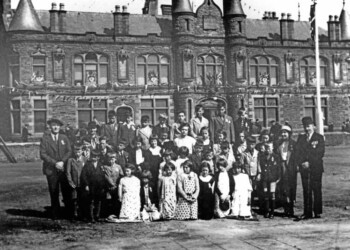 Kershader School Group in front of Stornoway Town Hall on the occasion of the Coronation in 1937: Kershader School Group at the Coronation ceremony in Stornoway 1937. Jimmy Tod (James Macdonald, Habost) sponsored the trip. BACK ROW J A Macleod, 11 Habost; A J Macleod, 2 Habost; D Macleod, 10 Garyvard; C Macleod, 3 Garyvard; D J Macrae, 8 Habost; J D Macaulay, 8 Kershader; C M Macleod, 4 Kershader; C I Macleod, 4 Kershader. SECOND ROW Donald Matheson, Gravir, Head Teacher; Mrs C Macrae, Teacher; P Macleod, 12 Habost; J MacKay, 3 Kershader; J MacDonald, 6 Kershader; I Macleod, 11 Habost; A MacKay, 3 Kershader; C B Macleod, 5 Garyvard; Mrs Matheson, Schoolhouse; Jimmy Tod, Habost. THIRD ROW D J MacKay, 3 Kershader; D Macleod, 1 Garyvard; C J Macrae, 14 Habost; D I MacKay, 11 Kershader; B Macrae, 8 Habost; M Matheson, Schoolhouse; J Macleod, 1 Garyvard; B M MacDonald, 11 Habost; J M MacDonald, Habost; D Macleod, 2 Kershader; R Macrae, 8 Habost. FRONT ROW D G Macrae, 8 Habost; C Macleod, 2 Kershader; M Macrae, 6 Habost; M A Macleod, 5 Garyvard; M M Macleod, 4 Kershader, A Matheson, Schoolhouse; C B Macleod, 4 Kershader, D Macleod, 12 Habost; M MacAulay, 8 Kershader; D A Macleod, 4 Kershader. Kershader class at Coronation Event 1937